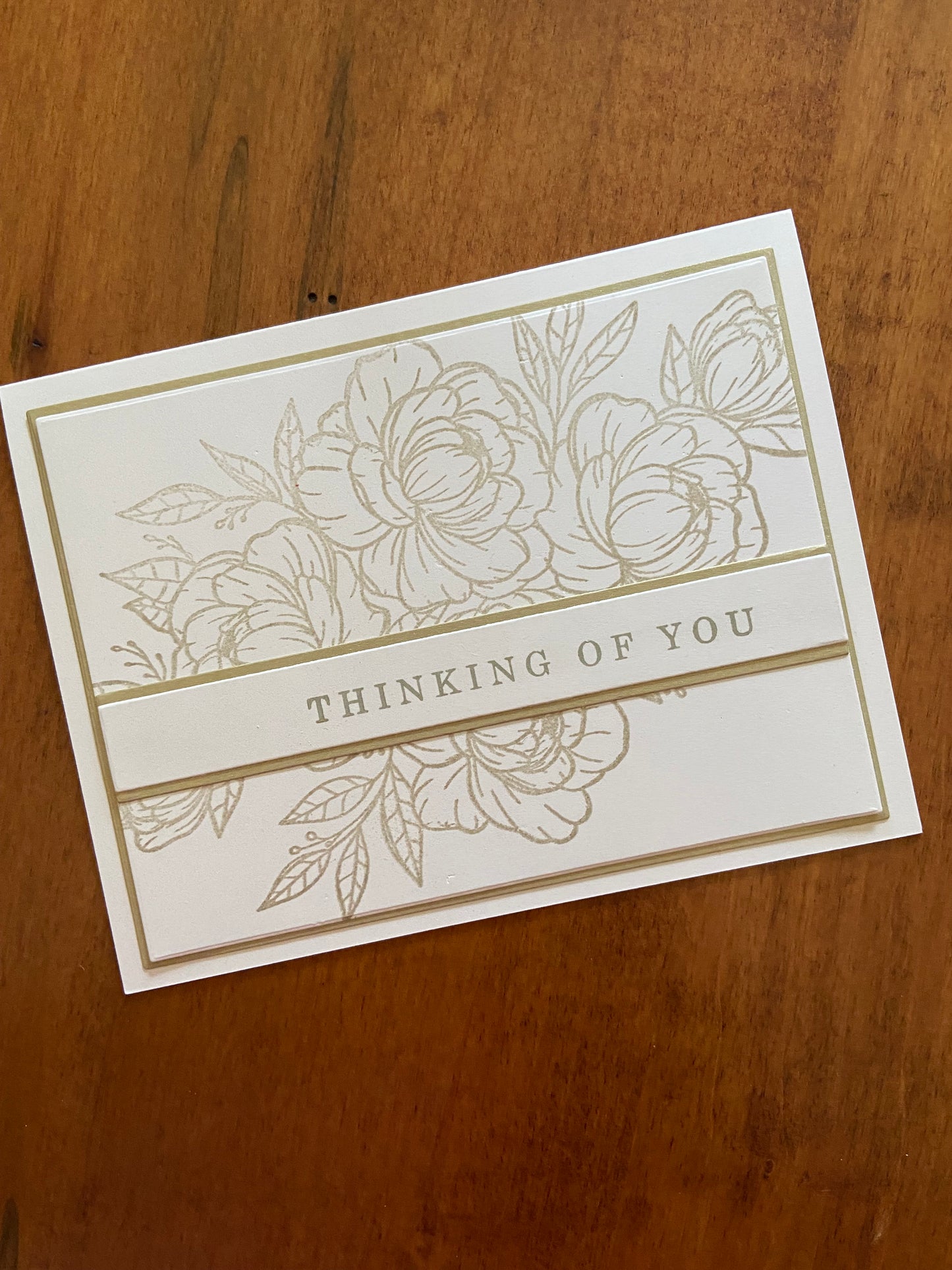 Gold and ivory handmade thinking of you card. Gold floral and greenery outline stamp with a gold thinking of you sentiment.