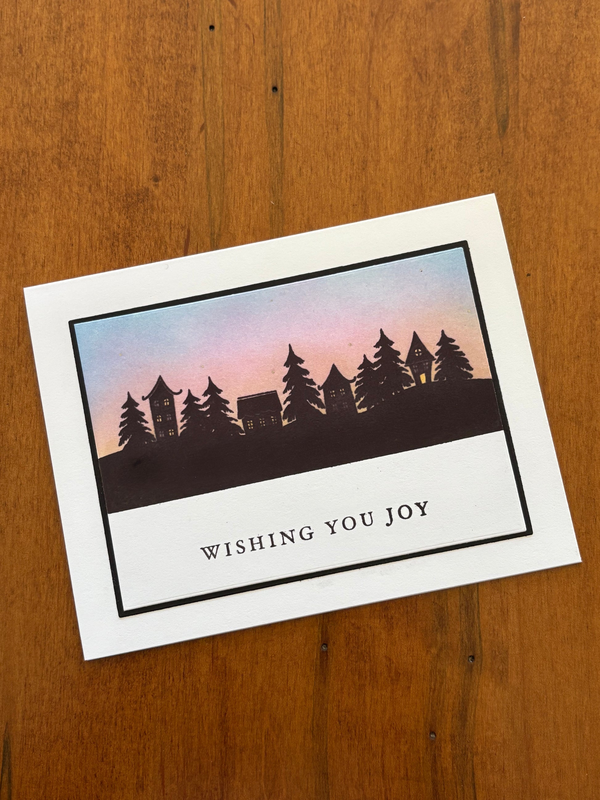 Greeting card with tree design, sunset and 'Wishing You Joy' text