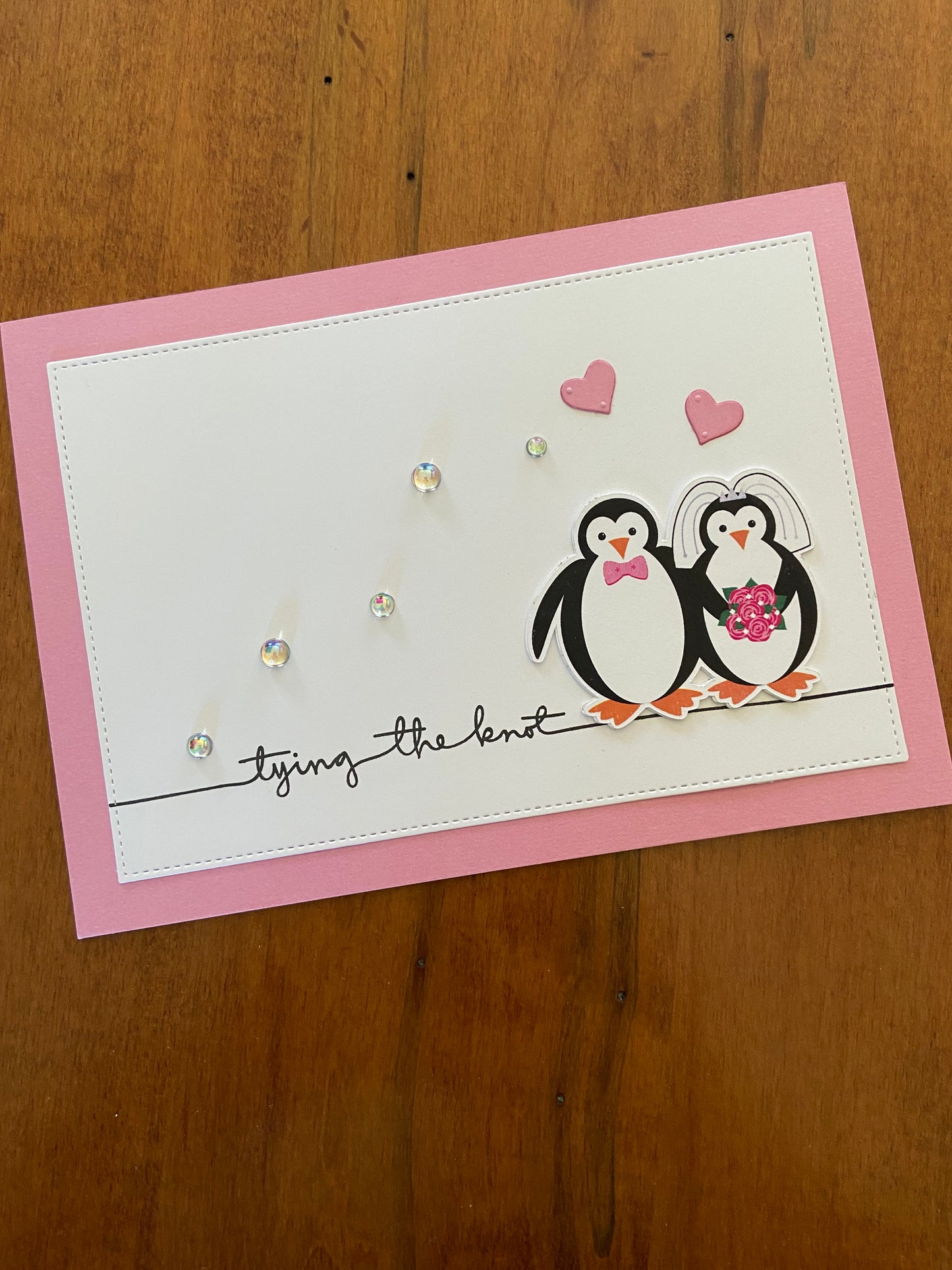 Tying the Knot Wedding Card pink and white Handmade card; penguin bride & groom with pink hearts above them. A little sparkle from some shiny pearls.