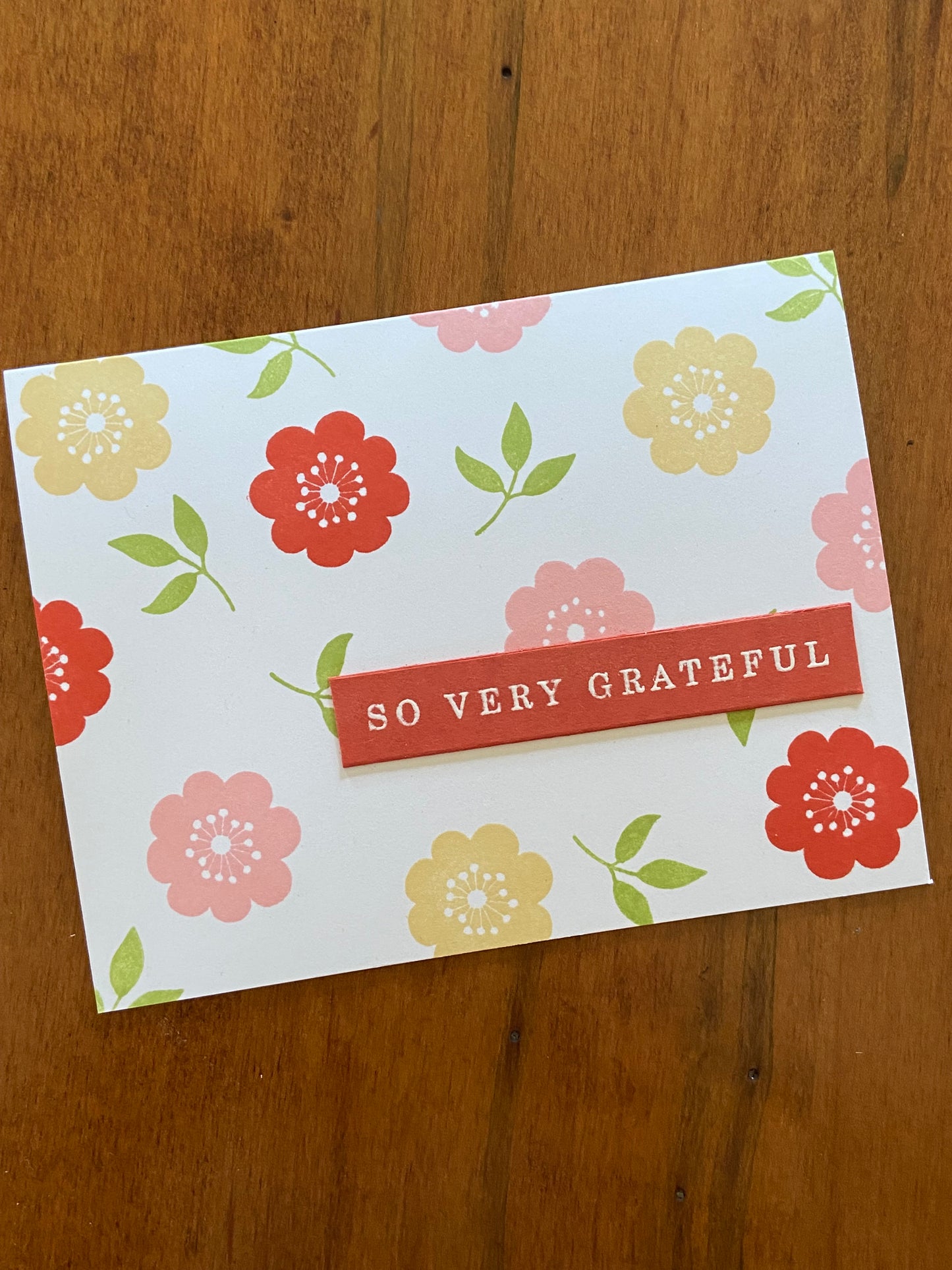 Floral So grateful for you card; part of a 2 card set; handmade. Pink, yellow and mahogany flowers with little green leaves.