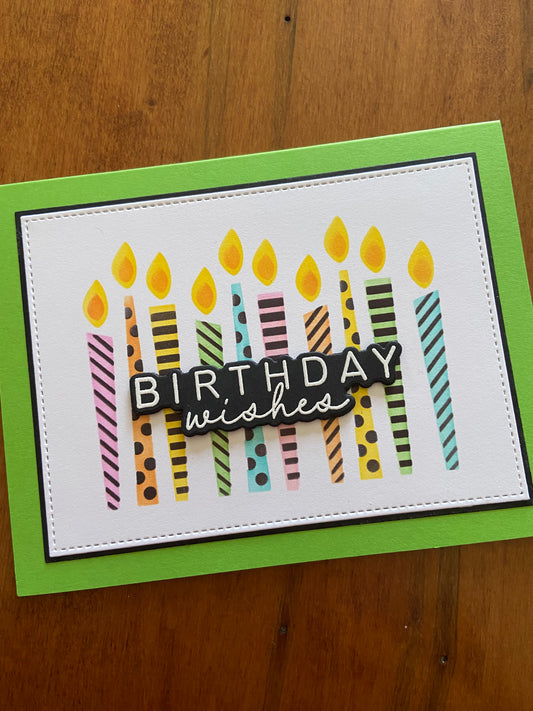 Handmade birthday card with vibrant stencilled birthday candles on a white background, mounted on a green notecard with the word 'Birthdays' and candle numbers.