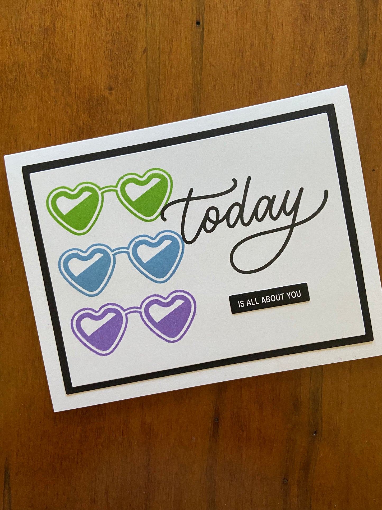 Handmade birthday celebration card with Today Is All About You sentiment and three heart-shaped sunglasses in purple, powder blue and green
