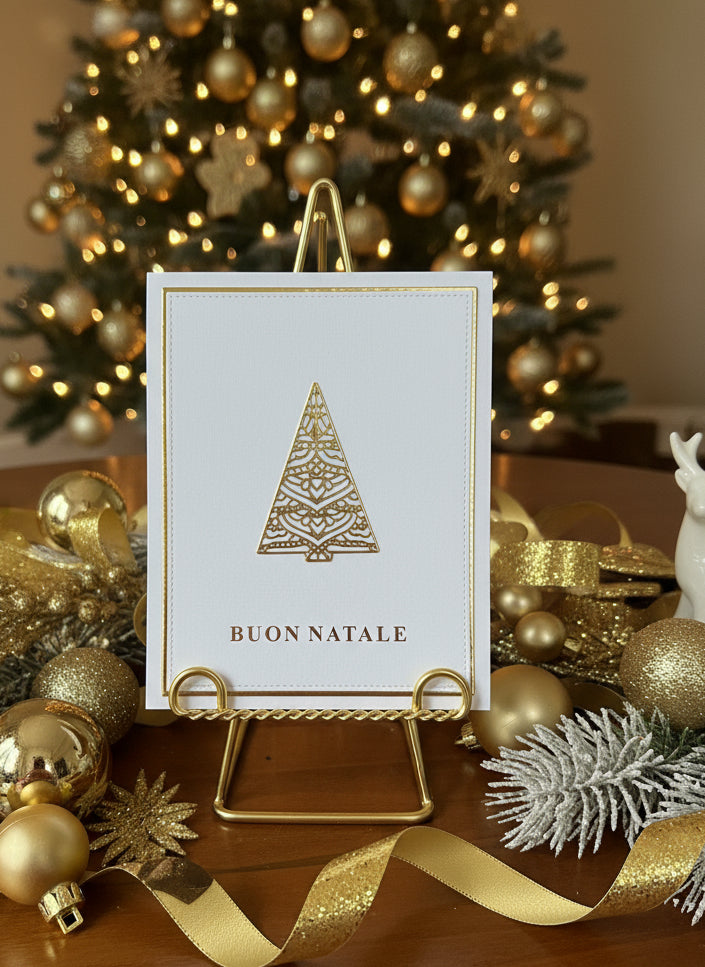Italian Christmas card with gold tree and 'Buon Natale' greeting displayed with festive holiday decorations