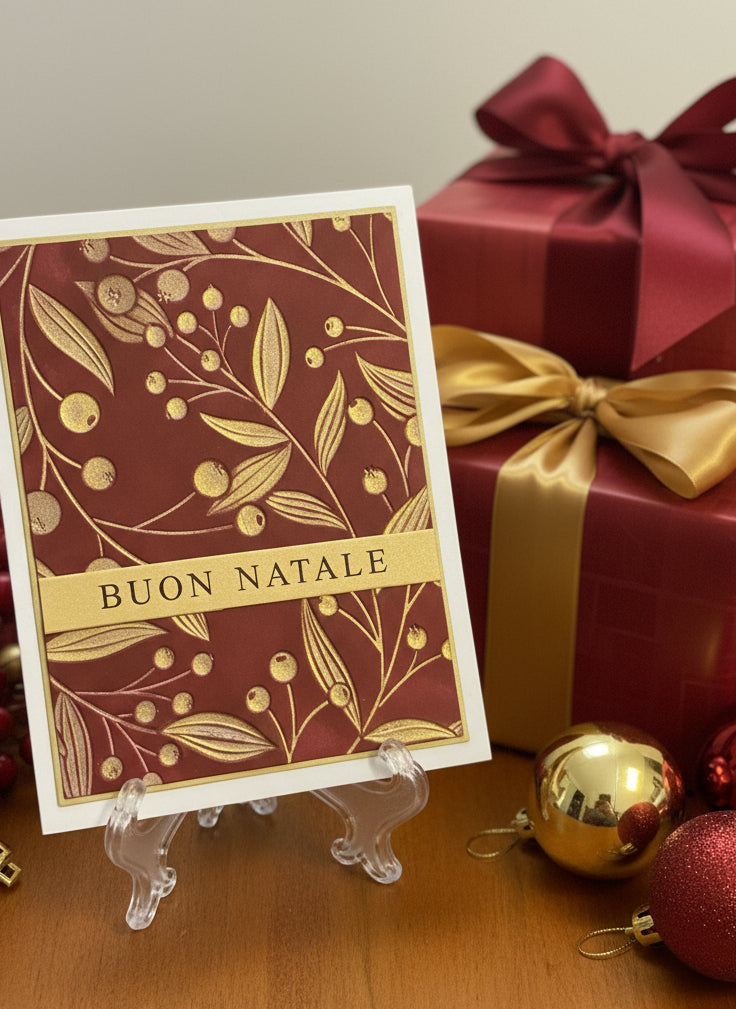 Italian Christmas card with gold berries and vine design on red background with 'Buon Natale' greeting displayed with wrapped gifts