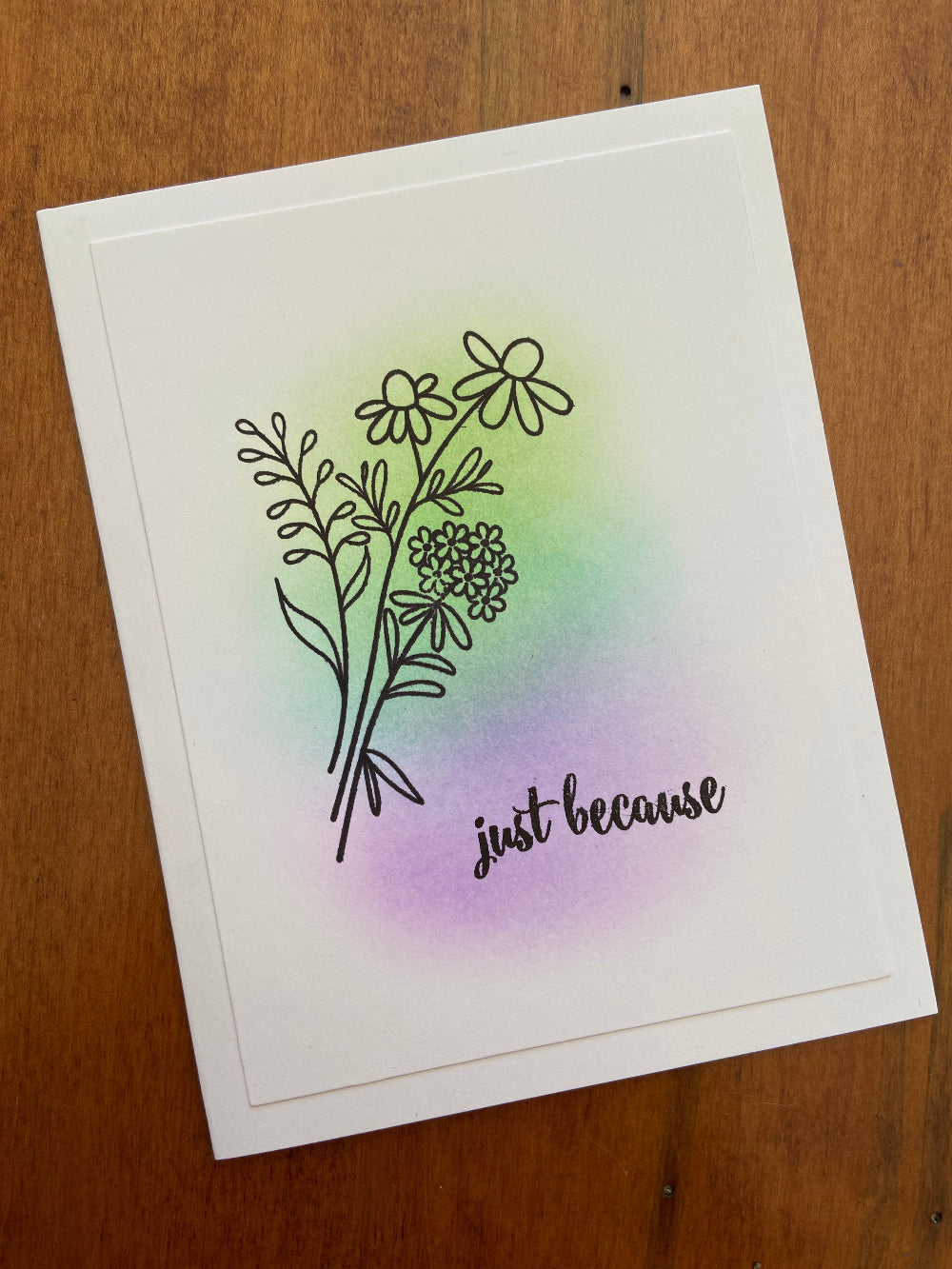 Handmade card with a floral stamp and the phrase 'just because' printed in black. The card is blank and appears to be made of a light-weight card stock.