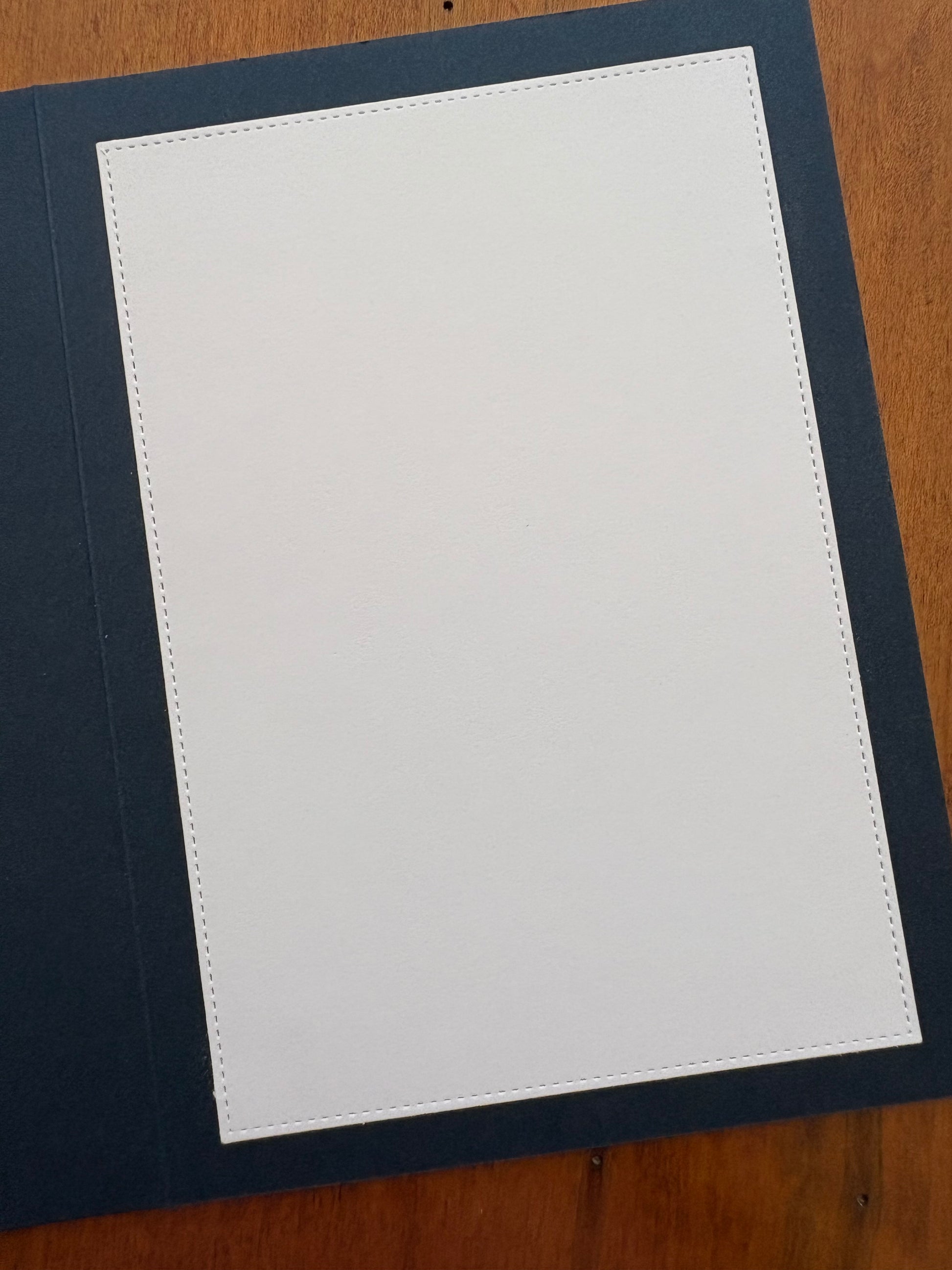 Showing the white cardstock lined inside of the dark blue card