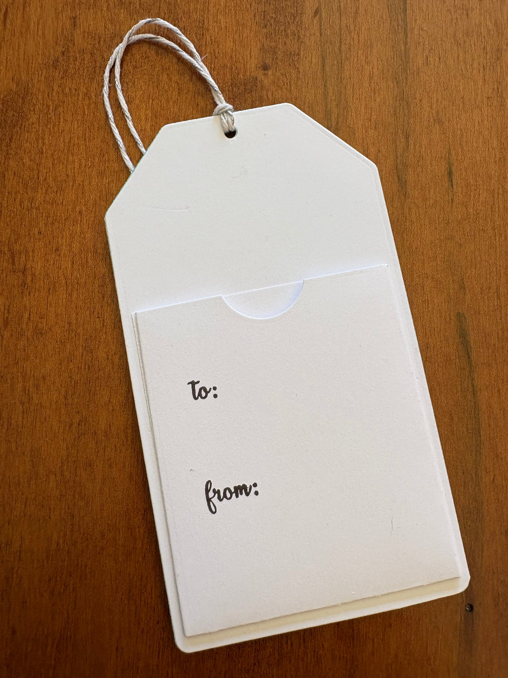 The backside of the gift card holder tag showing the pocket for the gift card and 'to and from' text