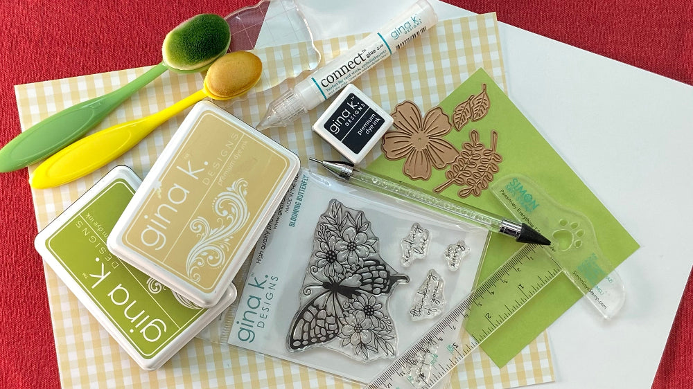Handmade card-making supplies and tools - patterned cardstock, stamps, ink, dies, and embellishments.