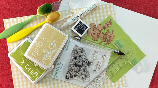Handmade card-making supplies and tools - patterned cardstock, stamps, ink, dies, and embellishments.