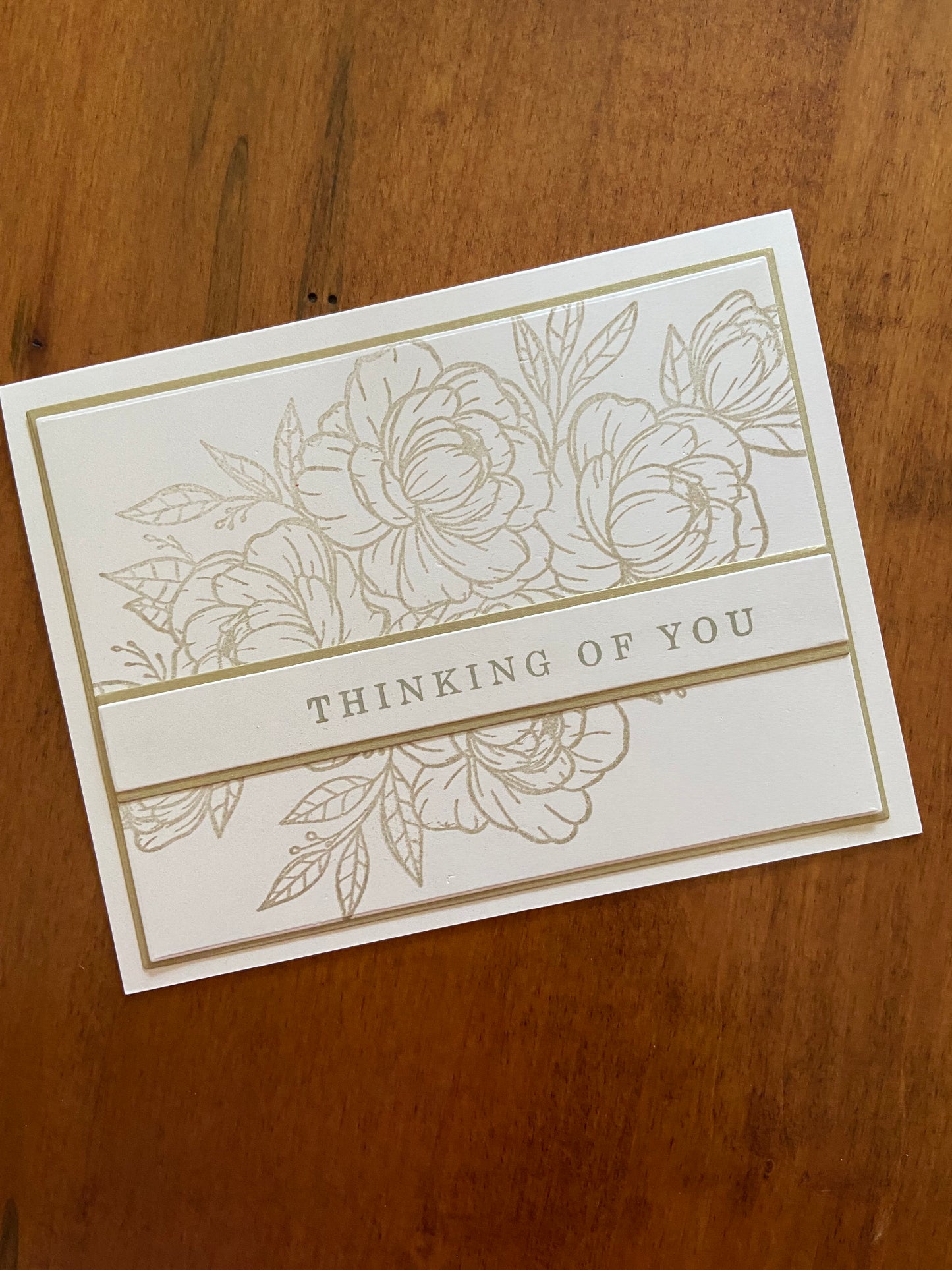 Gold and ivory handmade thinking of you card. Gold floral and greenery outline stamp with a gold thinking of you sentiment. 