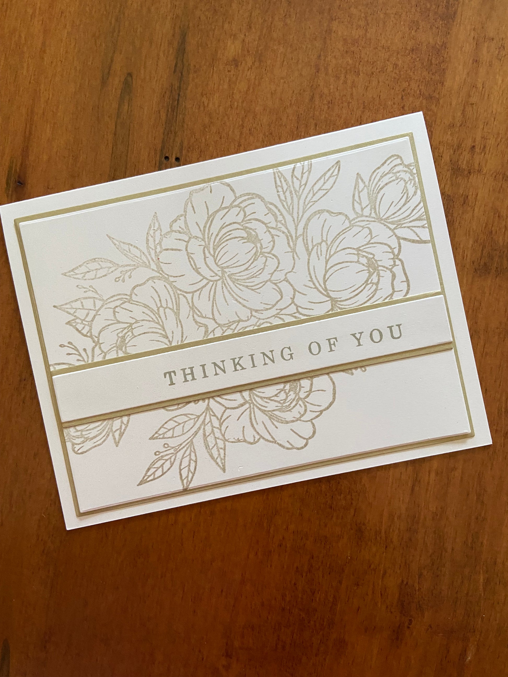 Gold and ivory handmade thinking of you card. Gold floral and greenery outline stamp with a gold thinking of you sentiment. 