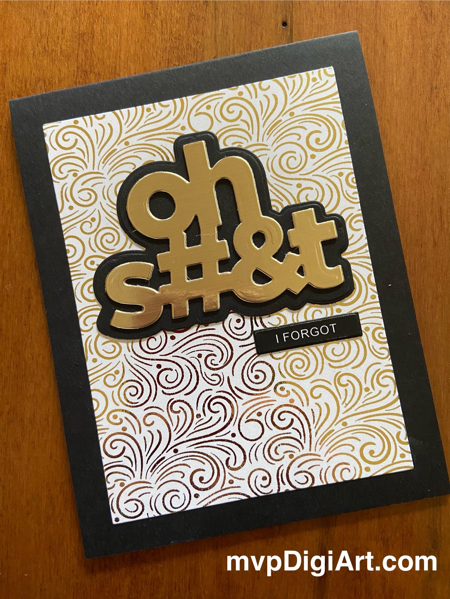 A handmade greeting card with a gold metallic background and the text 'oh S#&t I Forgot' in bold letters, mounted on a black shadow layer, with a patterned design.