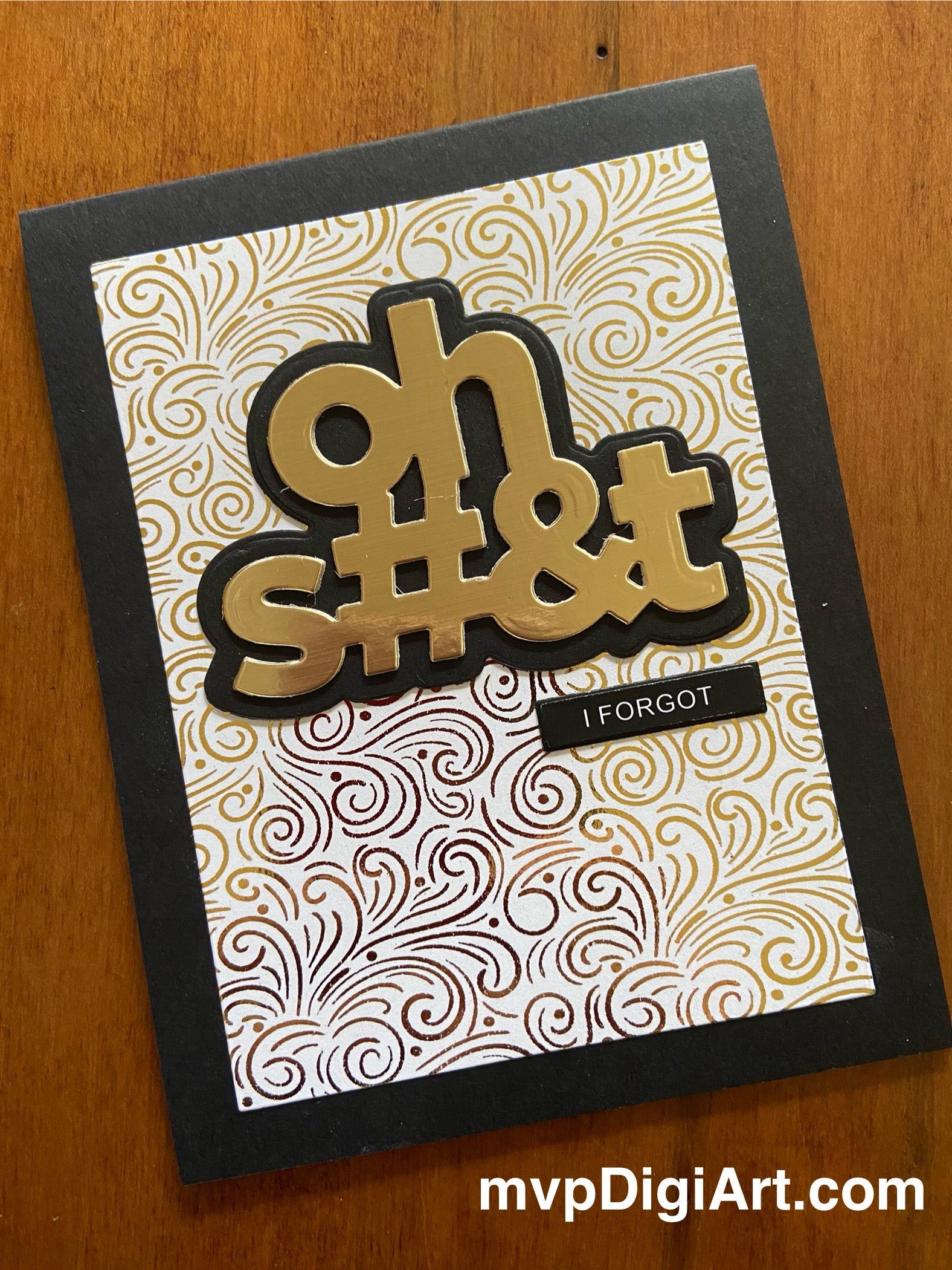 A handmade greeting card with a gold metallic background and the text 'oh S#&t I Forgot' in bold letters, mounted on a black shadow layer, with a patterned design.