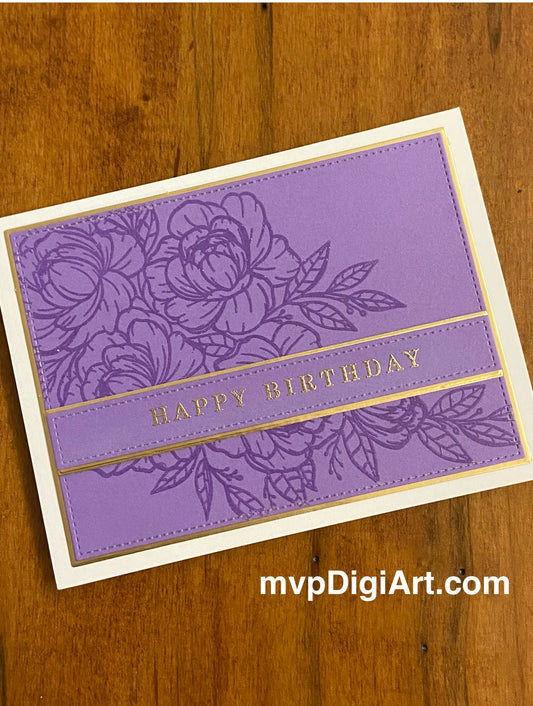 A birthday card with a floral design on purple with gold accents and 'Happy Birthday' text accross the stamped floral image on an ivory notecard