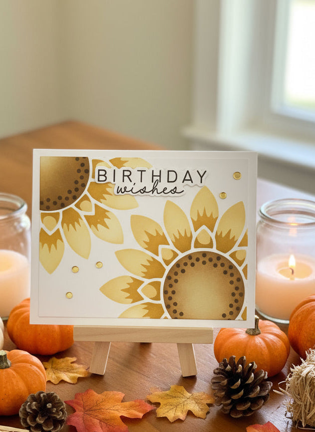 Autumn-themed birthday card with pumpkins, candles, and leaves on a table