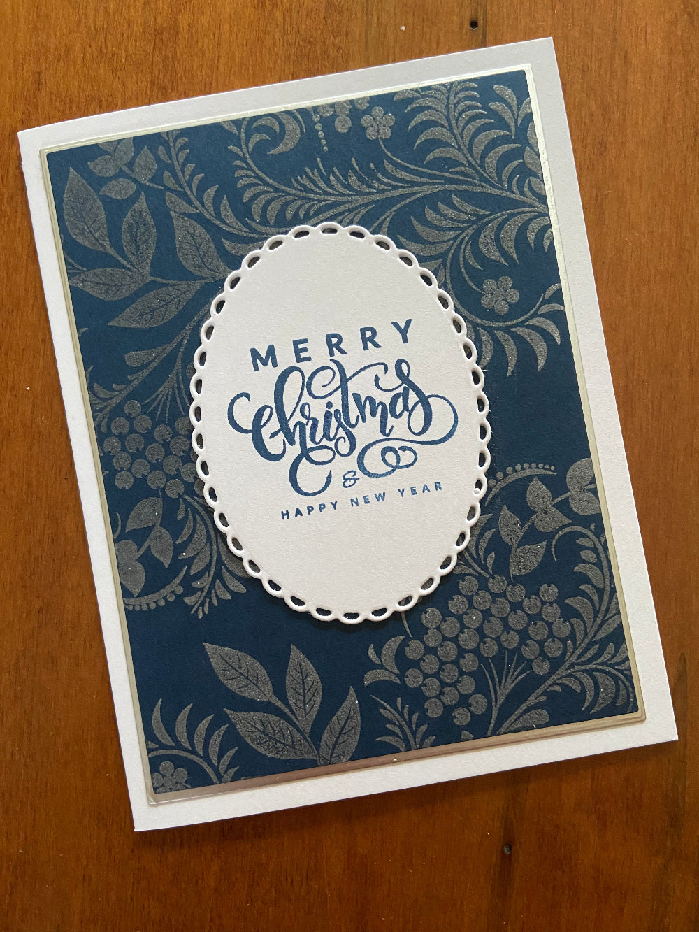 Handmade Christmas card with silver vines and berries on navy background with 'Merry Christmas & Happy New Year' sentiment - front view