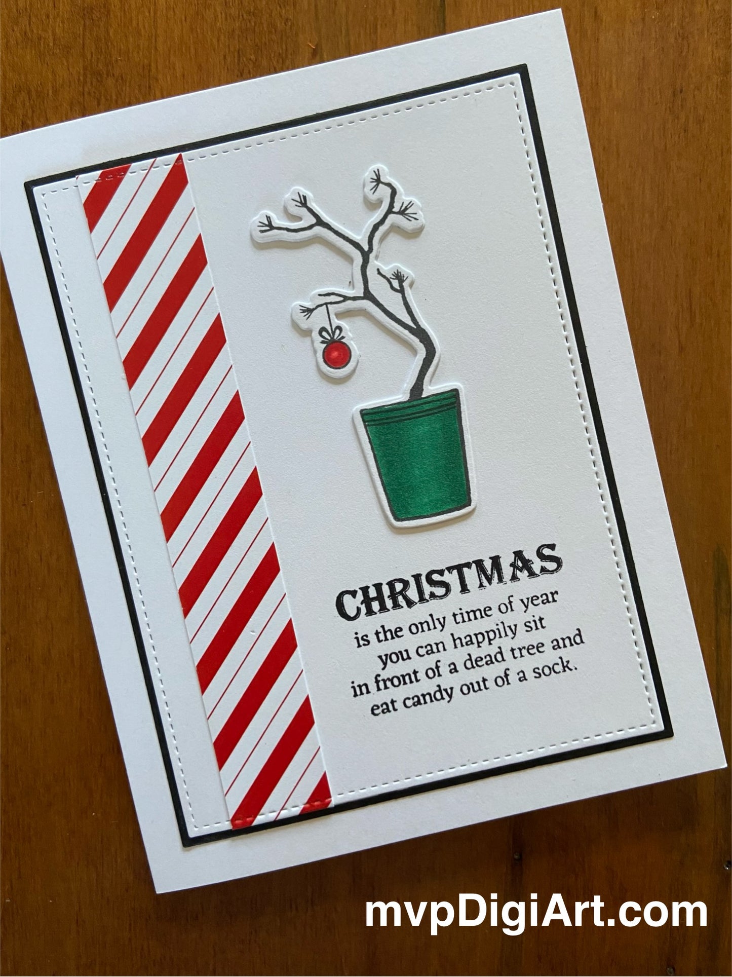 Handmade Christmas card featuring a coloured drawing of a 'Charlie Brown' tree with candy-cane stripes.