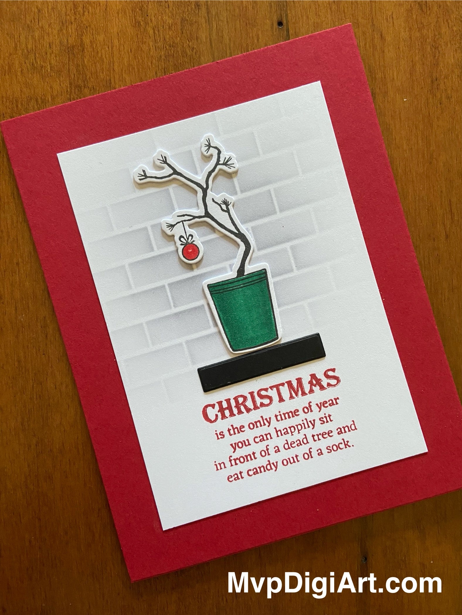 Handmade Christmas card with Charlie Brown Christmas tree on shelf on a red notecard