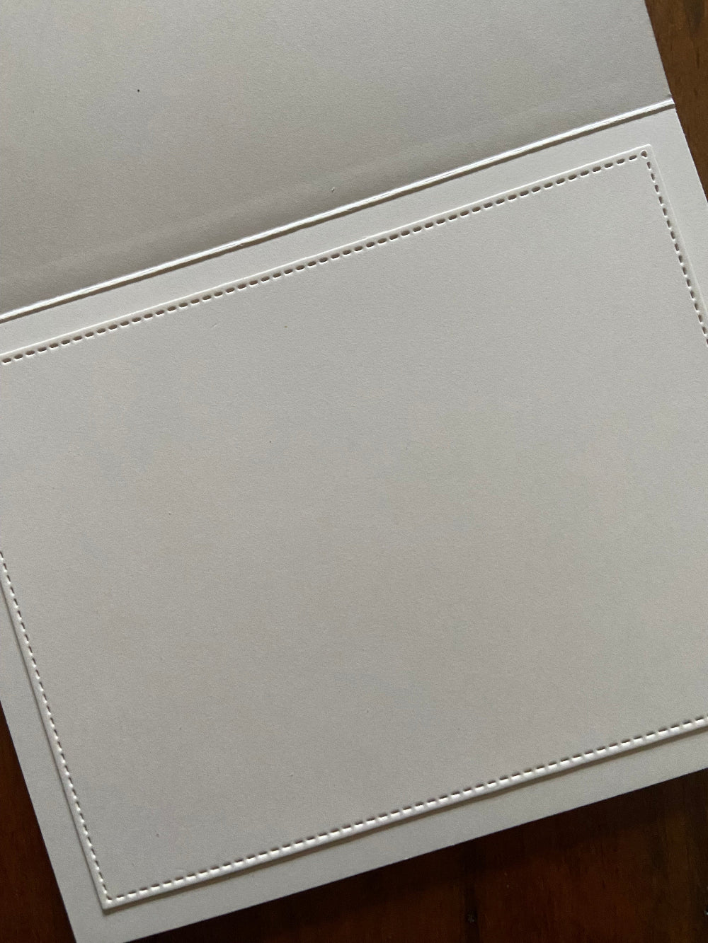 Inside view of handmade Christmas card showing stitched ivory panel for personal message