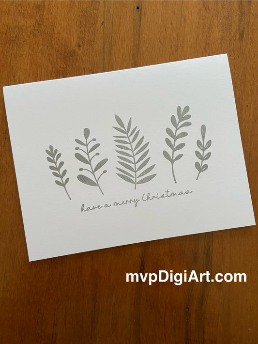 Handmade Christmas card with mixed botanical foliage in silver tones and 'Merry Christmas' sentiment on white background