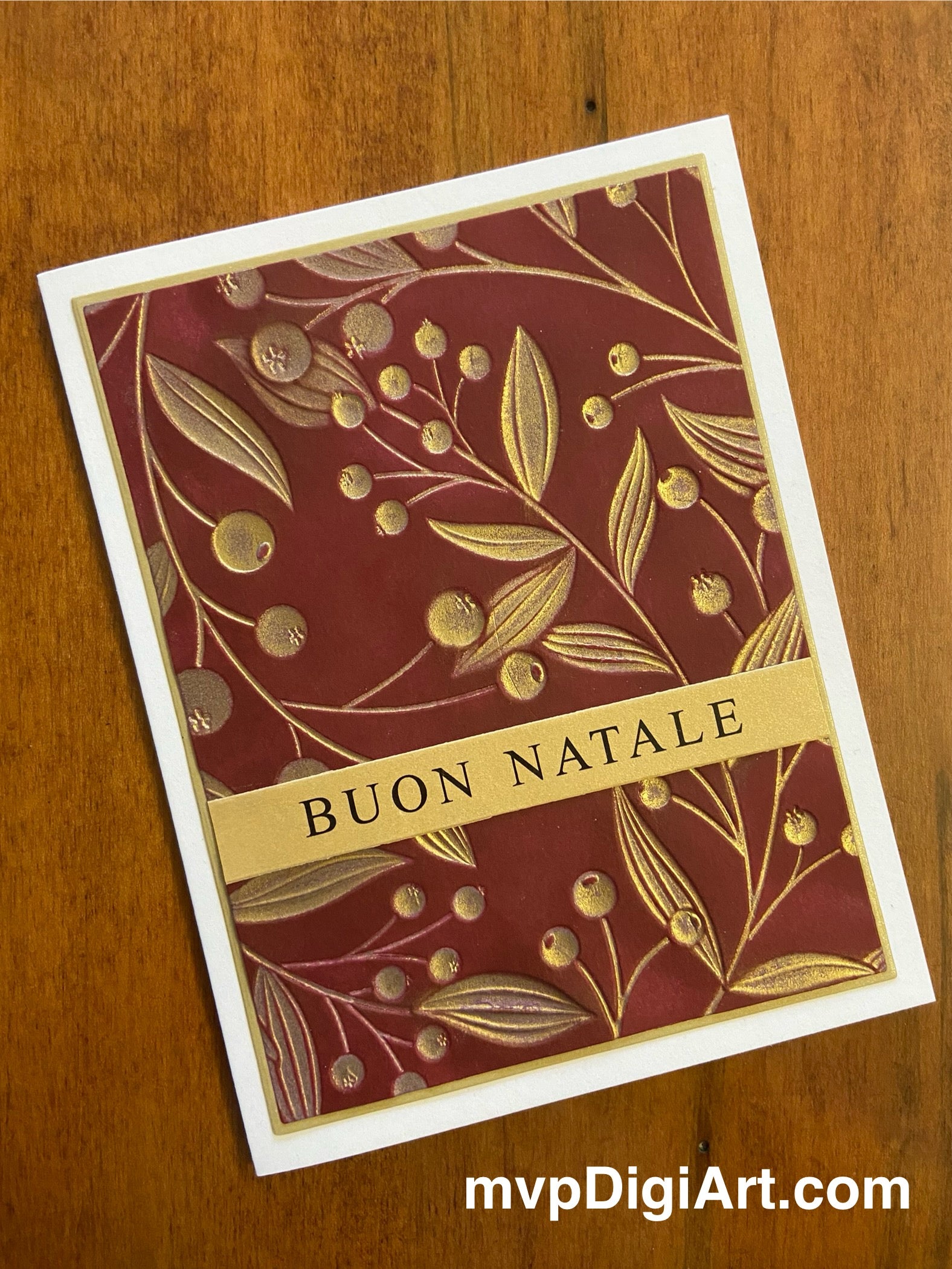 Handmade Italian Christmas card with gold berries and vine design on red background with Buon Natale greeting