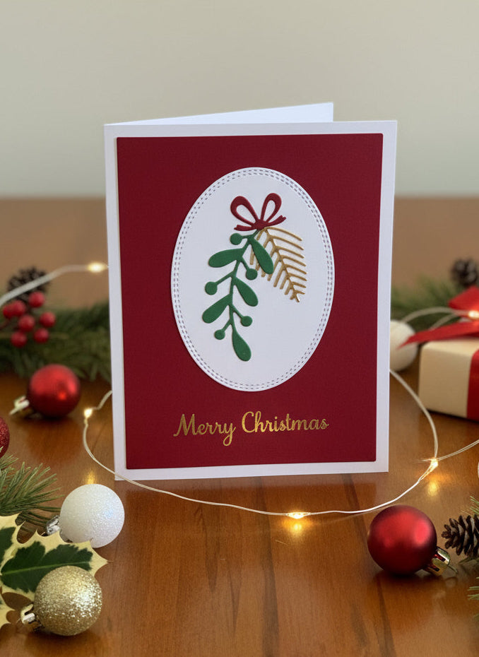 Christmas card with greenery and spruce sprigs tied with festive bow on red background with 'Merry Christmas' text displayed standing on a wooden table with festive decorations