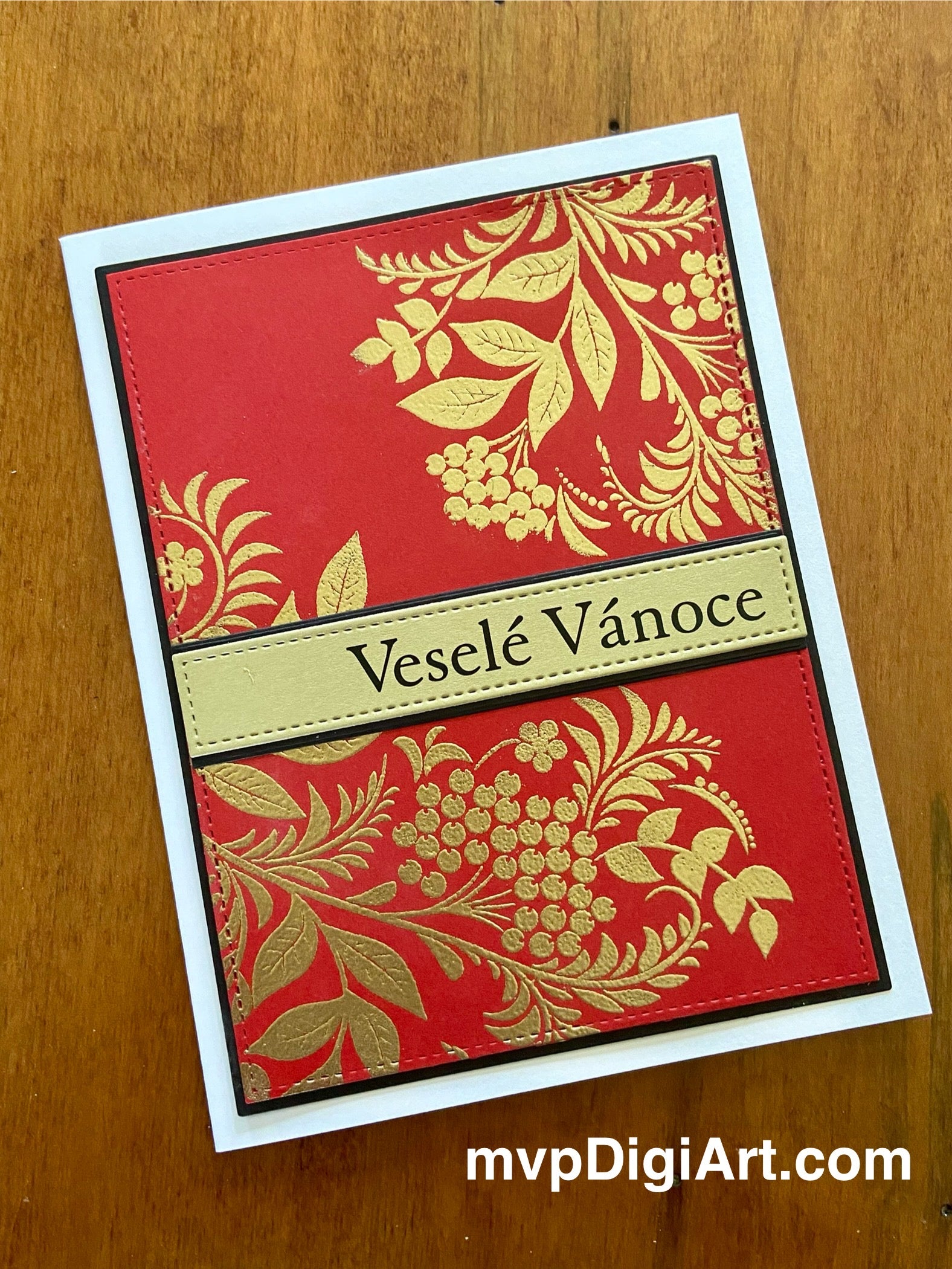 Handmade Czech Christmas card with embossed gold foliage on red stitched panel and Veselé Vánoce greeting on white background
