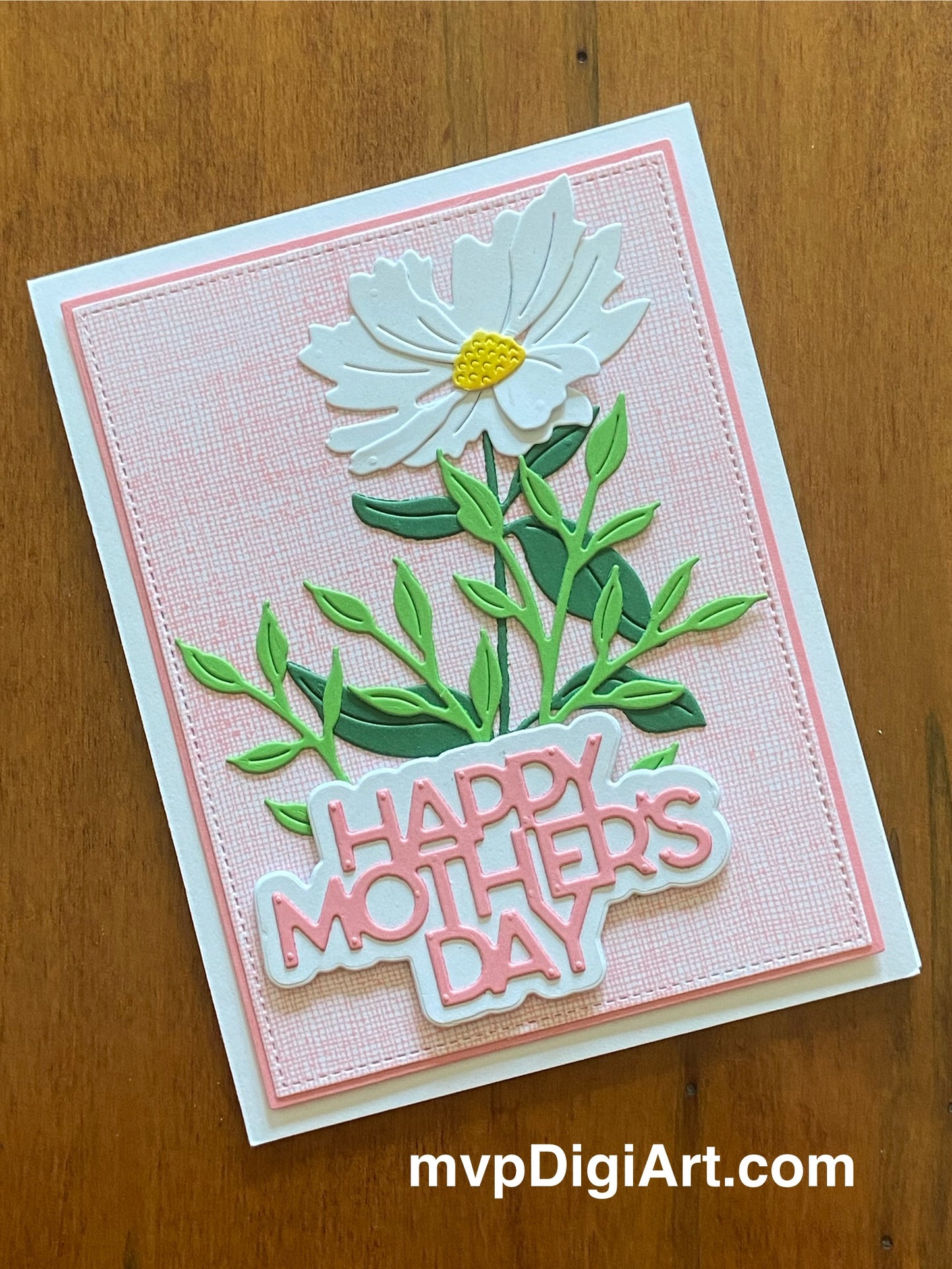 Mother's Day card with single daisy and greener and text 'happy mother's day' on a pink gauze patterned background
