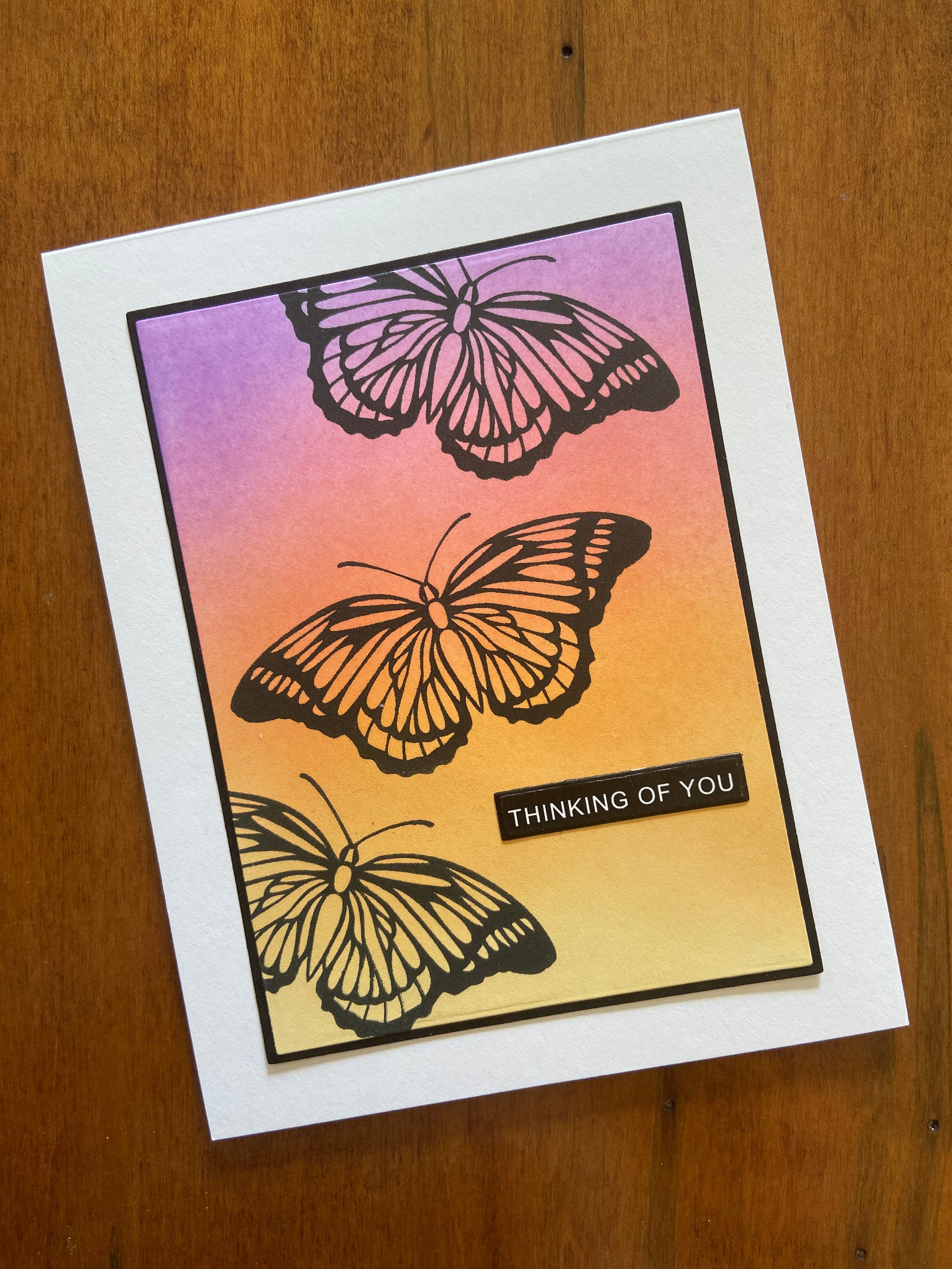 Greeting card with butterfly designs and 'Thinking of You' text on an ink blended background, part of the 4 pack set