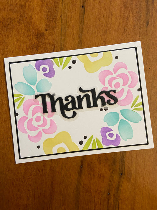 Handmade thank you card with pastel floral wreath in purple, pink, yellow, green and turquoise with black Thanks sentiment and polka dot accents
