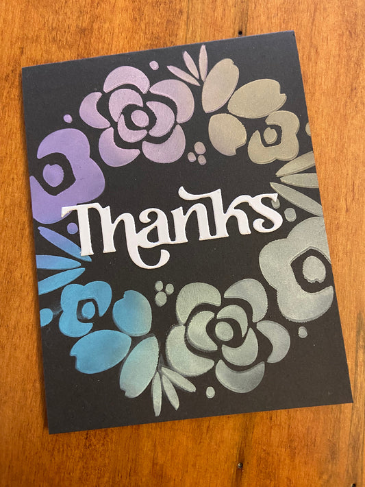 Handmade thank you card with soft pastel floral wreath on bold black background