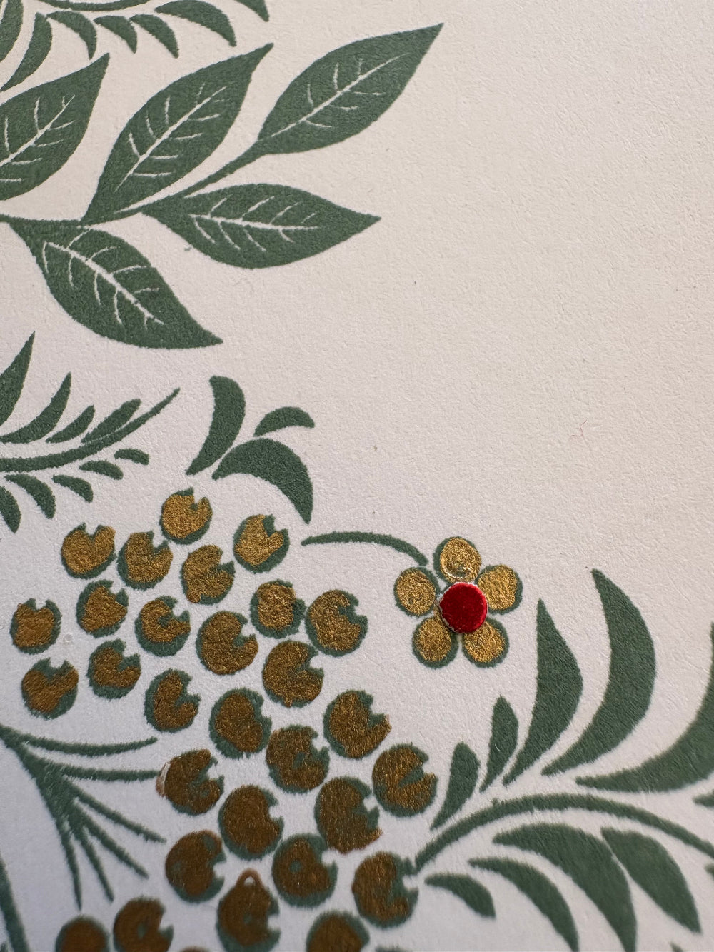 Decorative design with green leaves and gold floral patterns close up of gift card holder tag