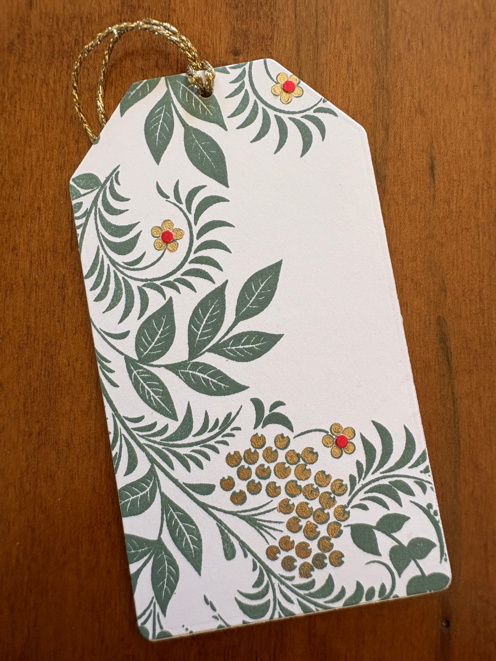 Decorative handmade gift card holder with floral and leaf pattern, green, red, and gold