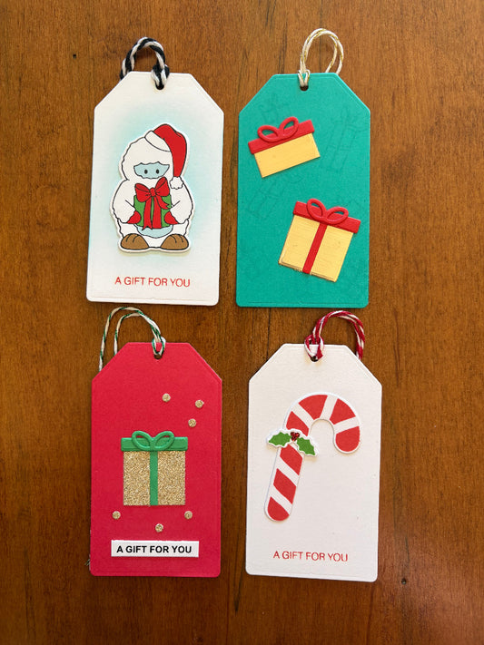 Christmas gift tags featuring yeti, gifts, and candy cane designs - front view