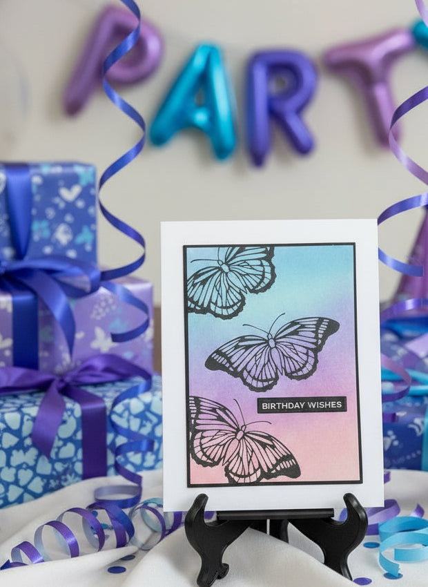 Birthday-themed setup with butterfly card, gifts, and party decorations.