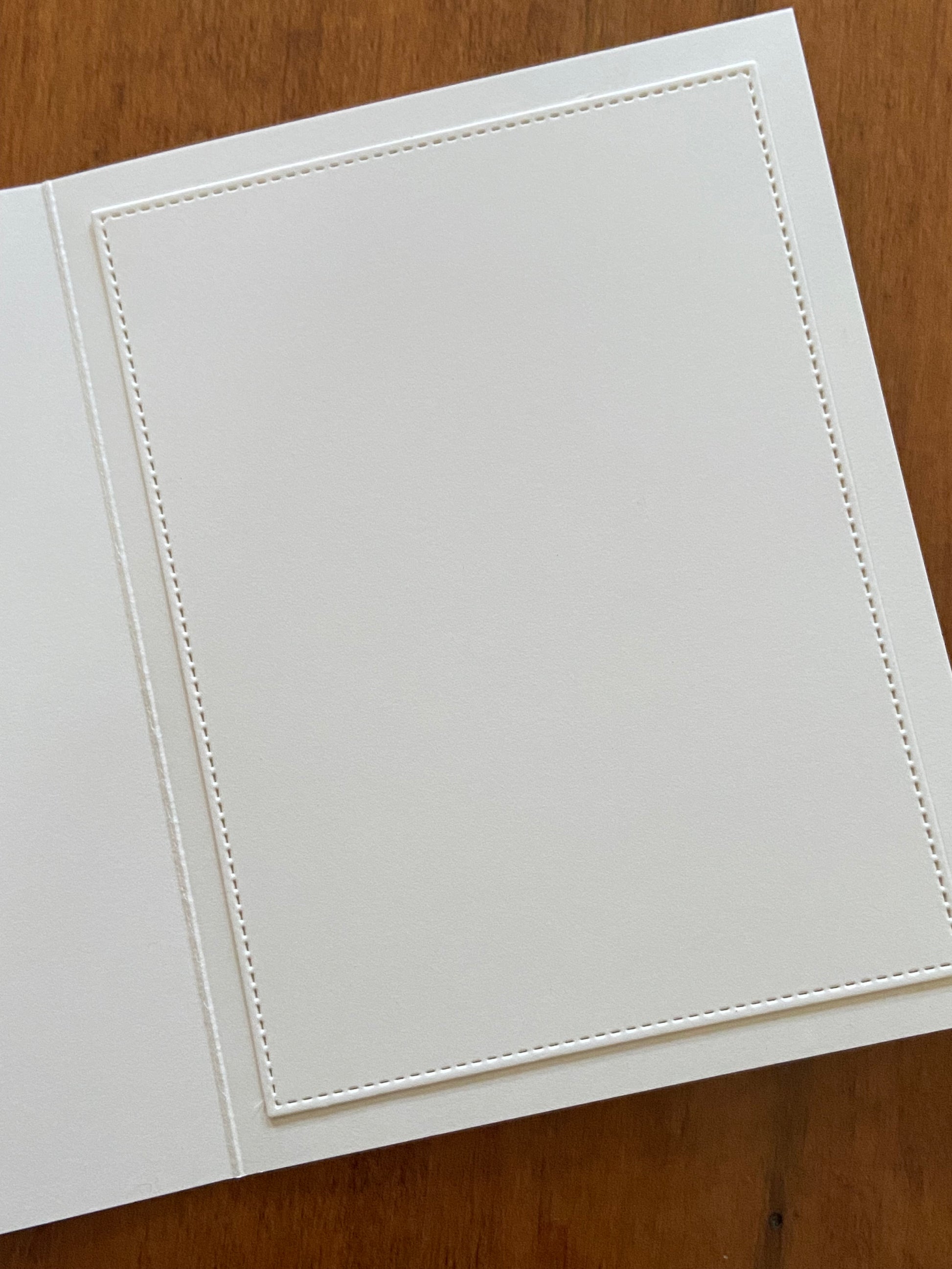 Showing the ivory stitched panel on the inside of the card. 