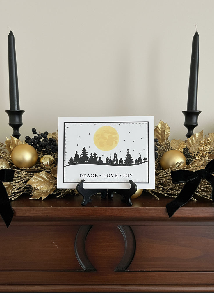 Christmas card on decorated mantle with candles, gold ornaments
