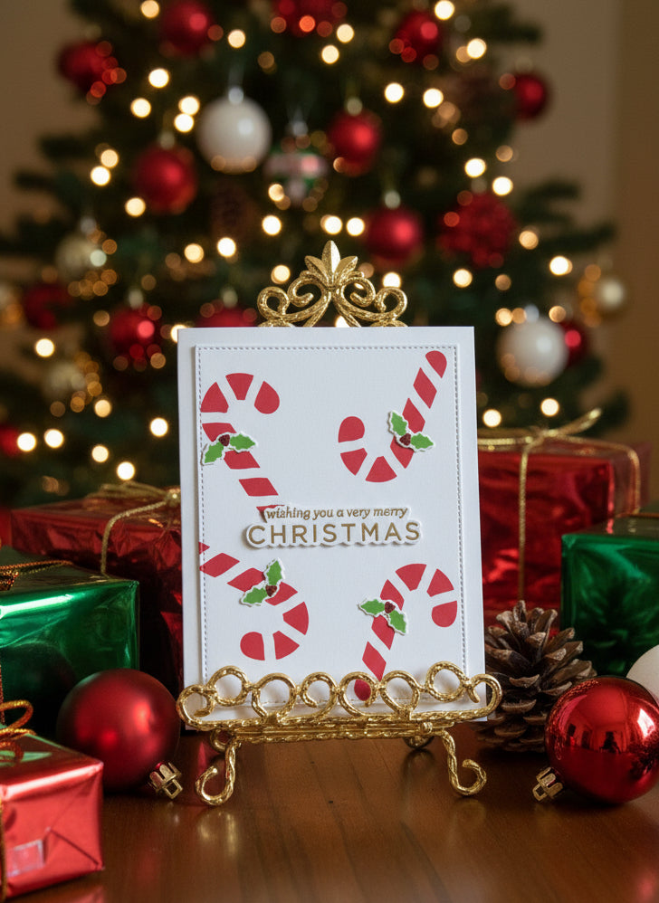 Christmas card with candy canes and holly decorations with gold embossed sentiment displayed with festive holiday decorations