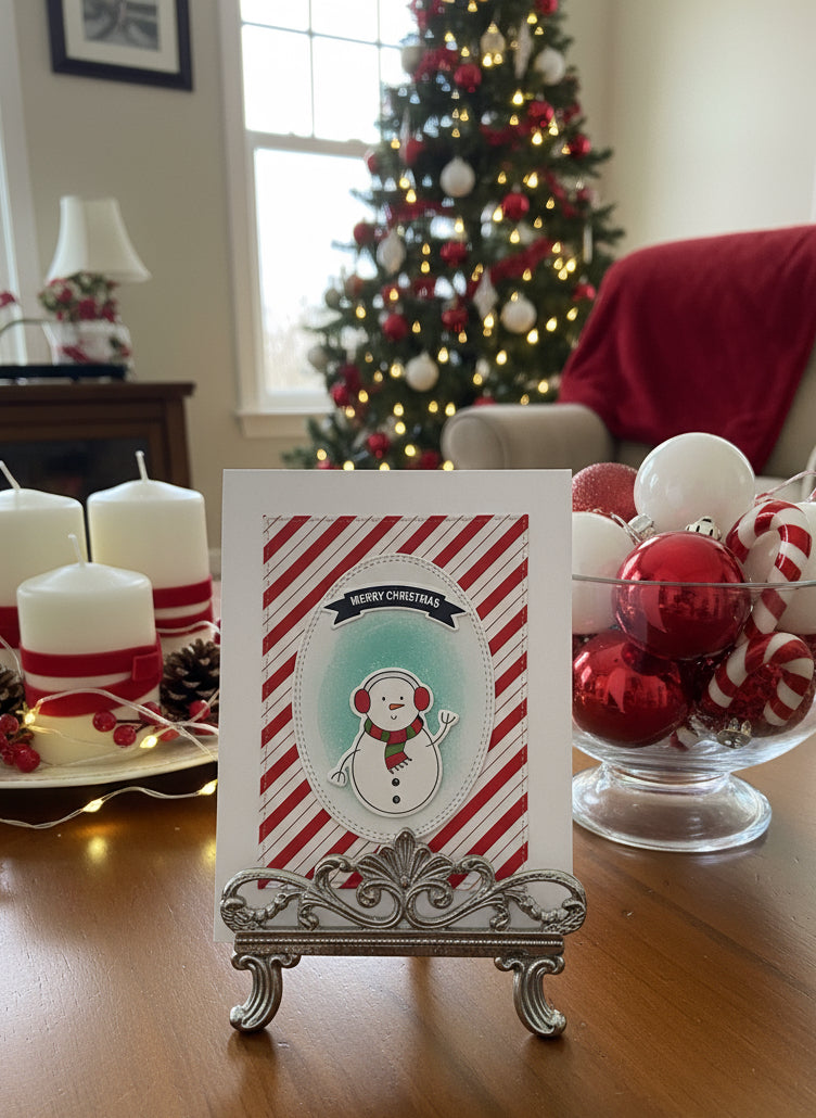 Christmas card with cute snowman on candy cane striped background displayed with festive holiday decorations