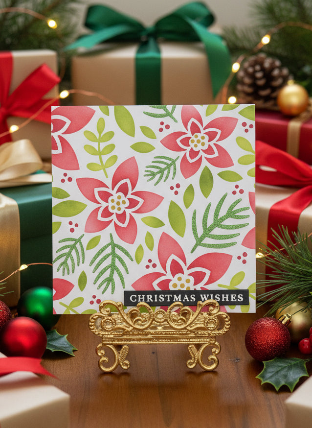 Square Christmas card with modern poinsettia design and 'Christmas Wishes' text displayed with festive holiday decorations
