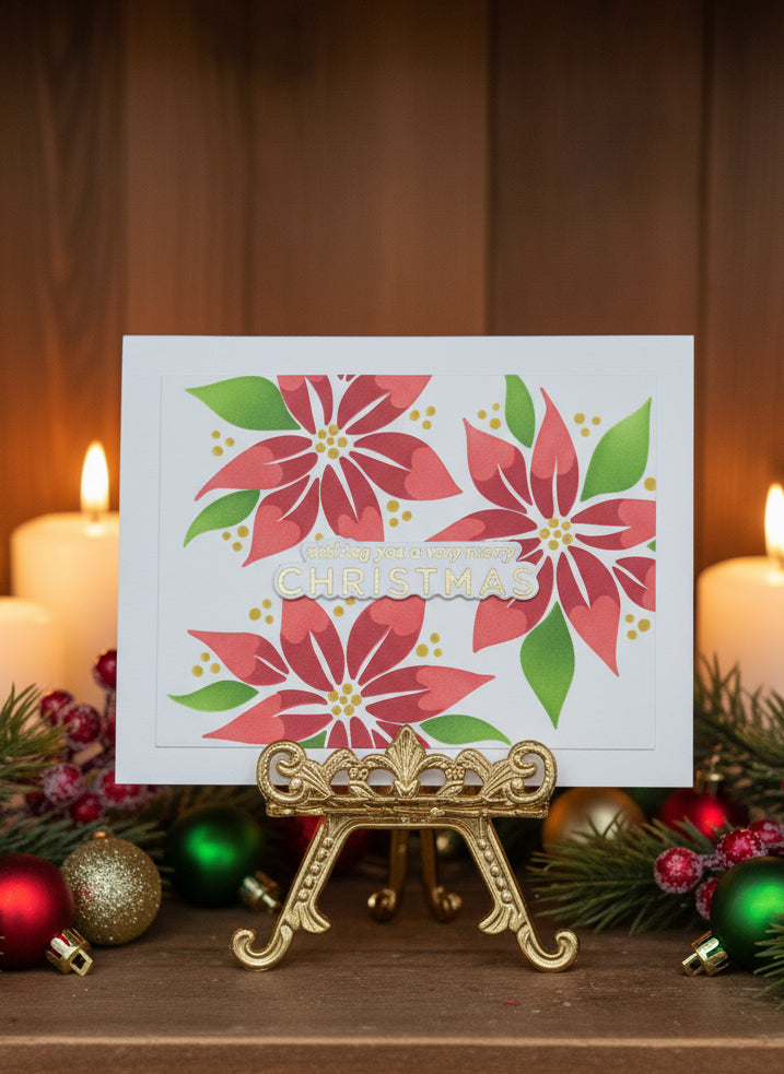 Christmas card with contemporary poinsettia design on a decorative stand with candles and ornaments.