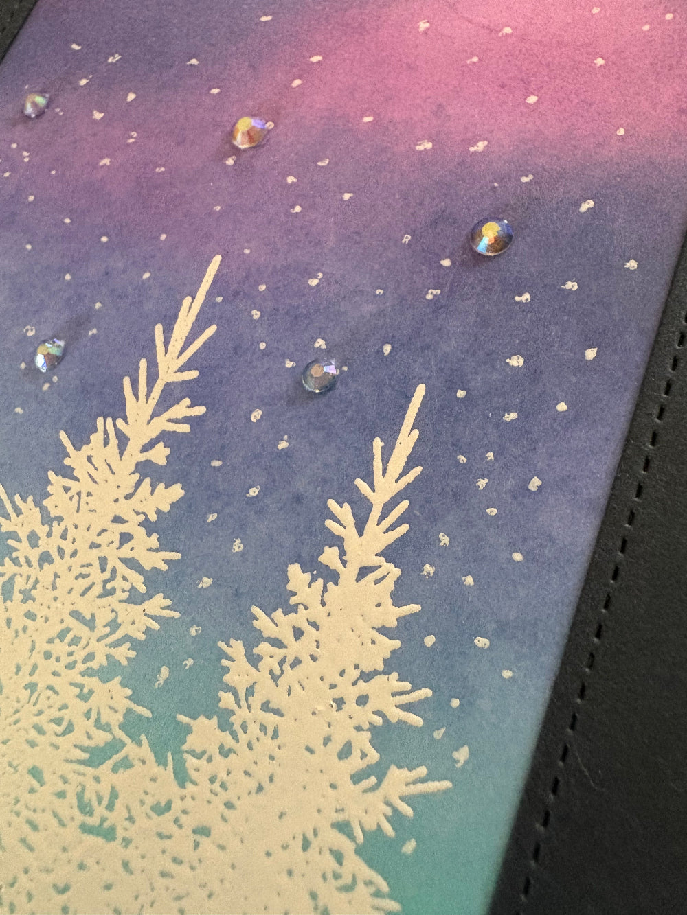 Decorative surface with snowflake design and clear gems on a gradient background