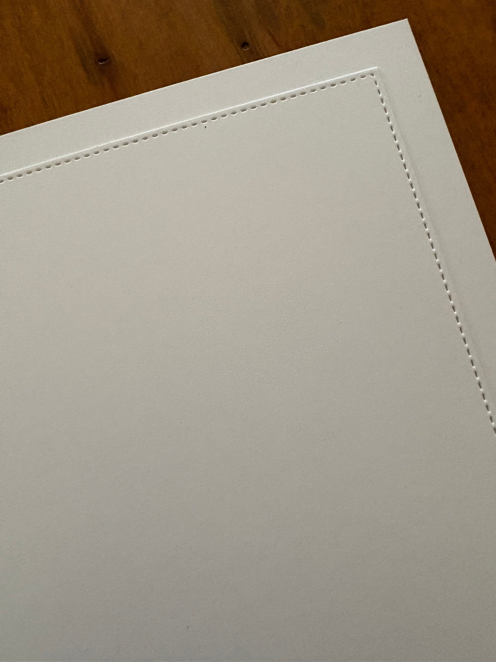 Close-up of a white stitched panel on the inside for your personal message
