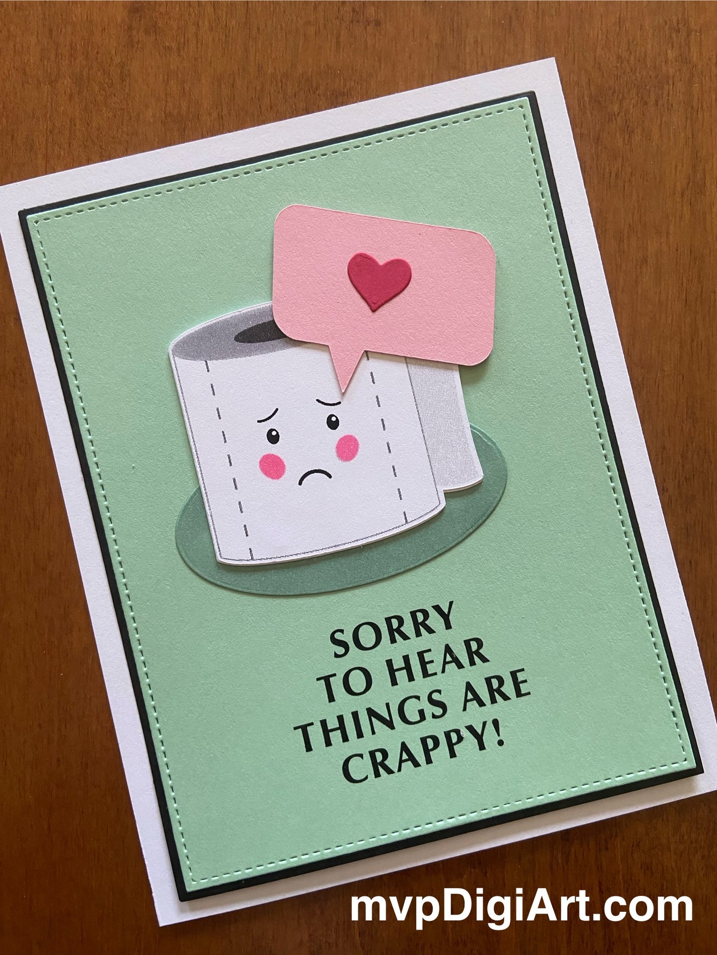 Encouragement card with an original artwork cartoon toilet paper roll with heart speech bubble and text 'Sorry to hear things are crappy' on a light green background.