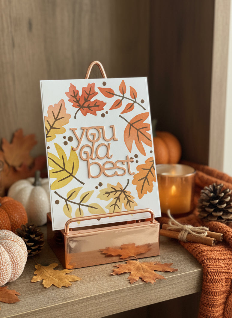 'You da best' encouragement card with autumn leaves displayed on decorated shelf 