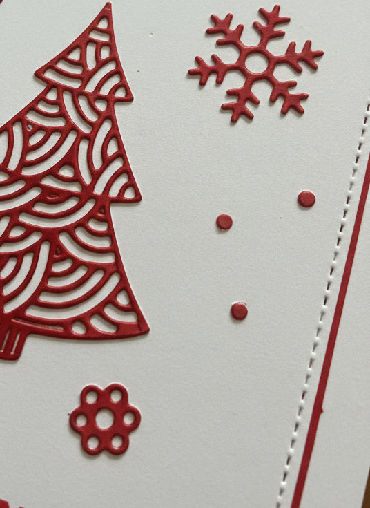 Close-up detail of French Christmas card showing red ornate tree with snowflakes and 'Joyeux Noël' text on white background