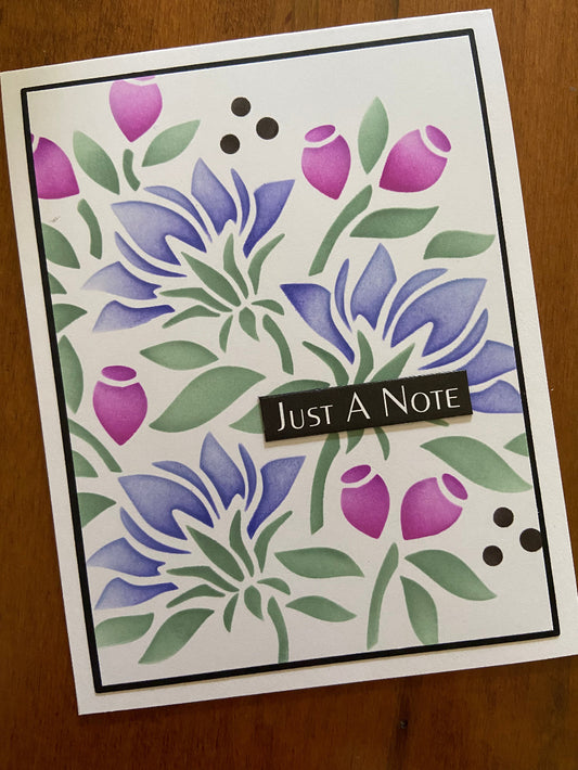 Greeting card with bold modern floral design and 'Just A Note' text on a white notecard