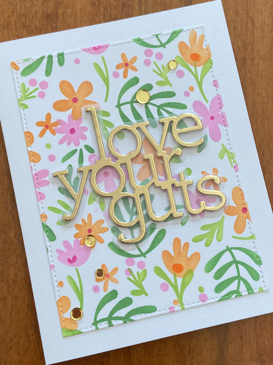 A fun love card with floral design and gold die cut text 'love your guts' on a white notecard