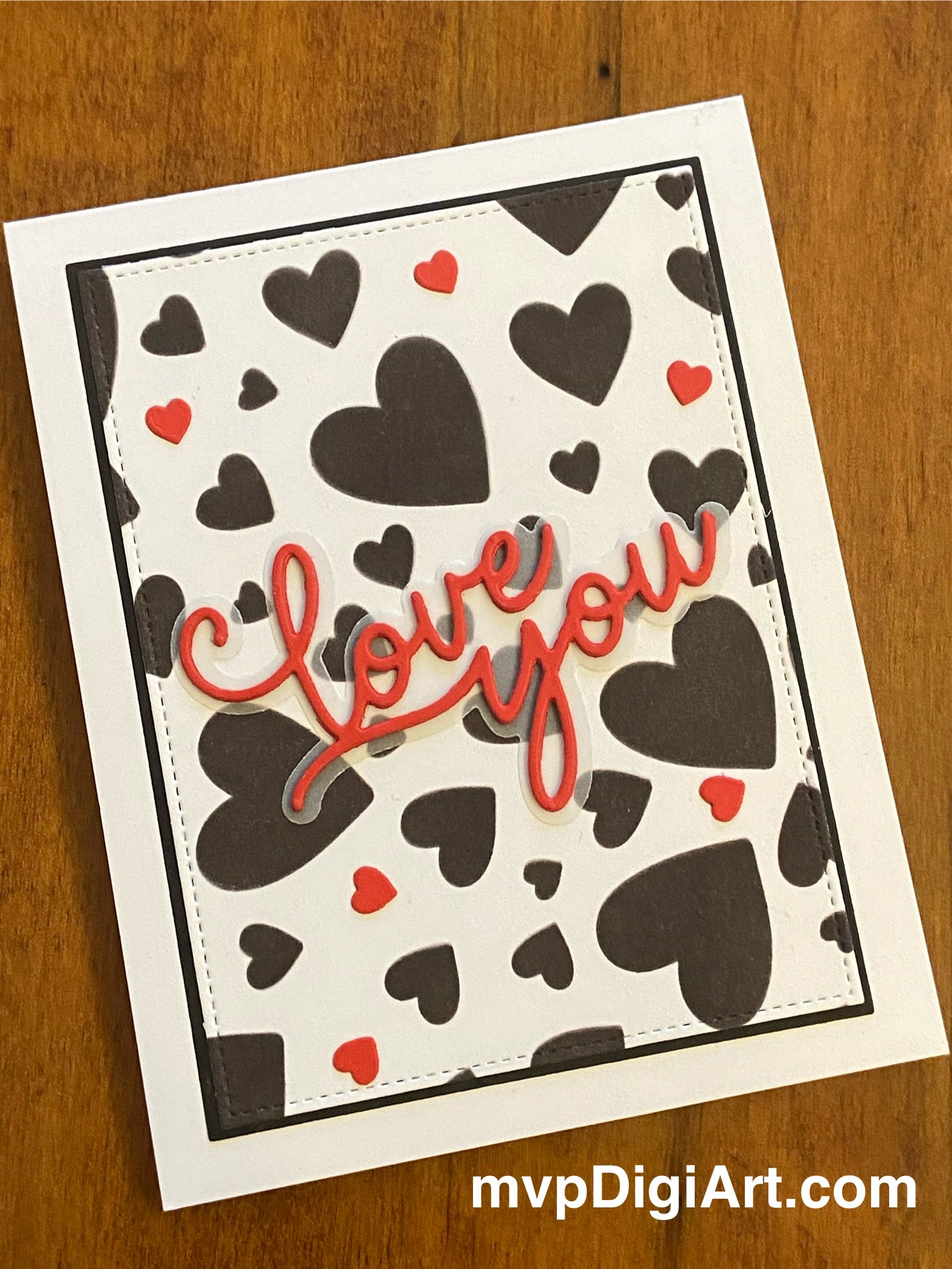 Handmade love card with modern design featuring red and black hearts on white background with 'Love You' sentiment in red cursive