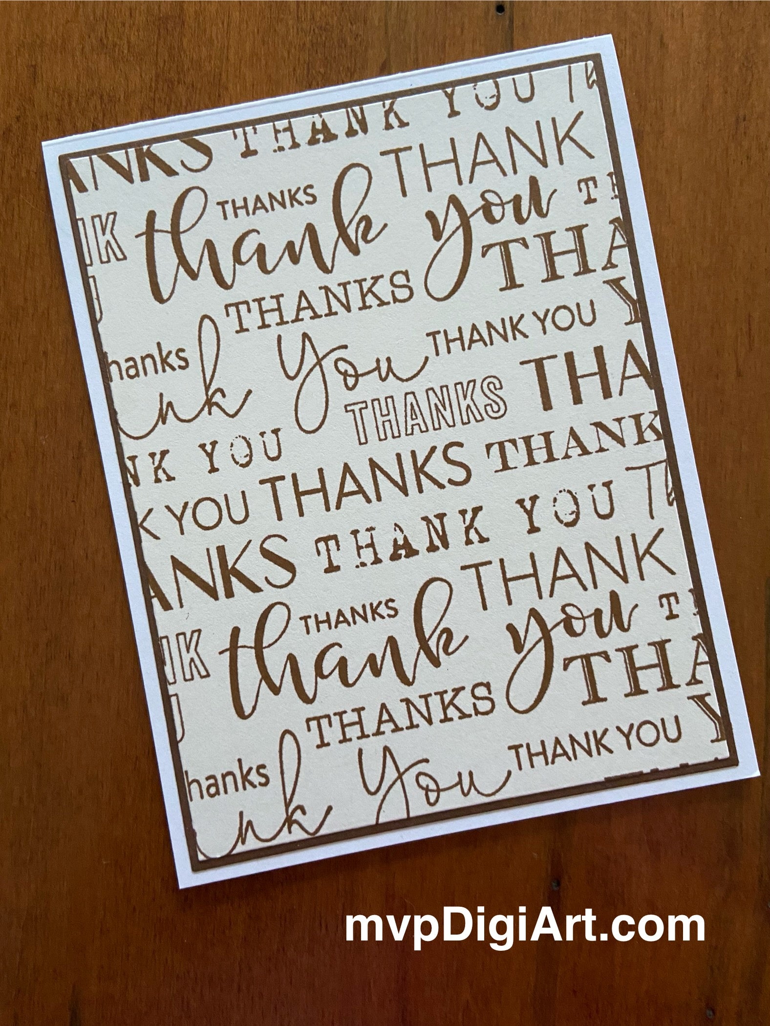 Front view of card 1 of the 2-pack handmade thank you cards showing thank you in a variety of fonts in brown plus layered panels with matte border